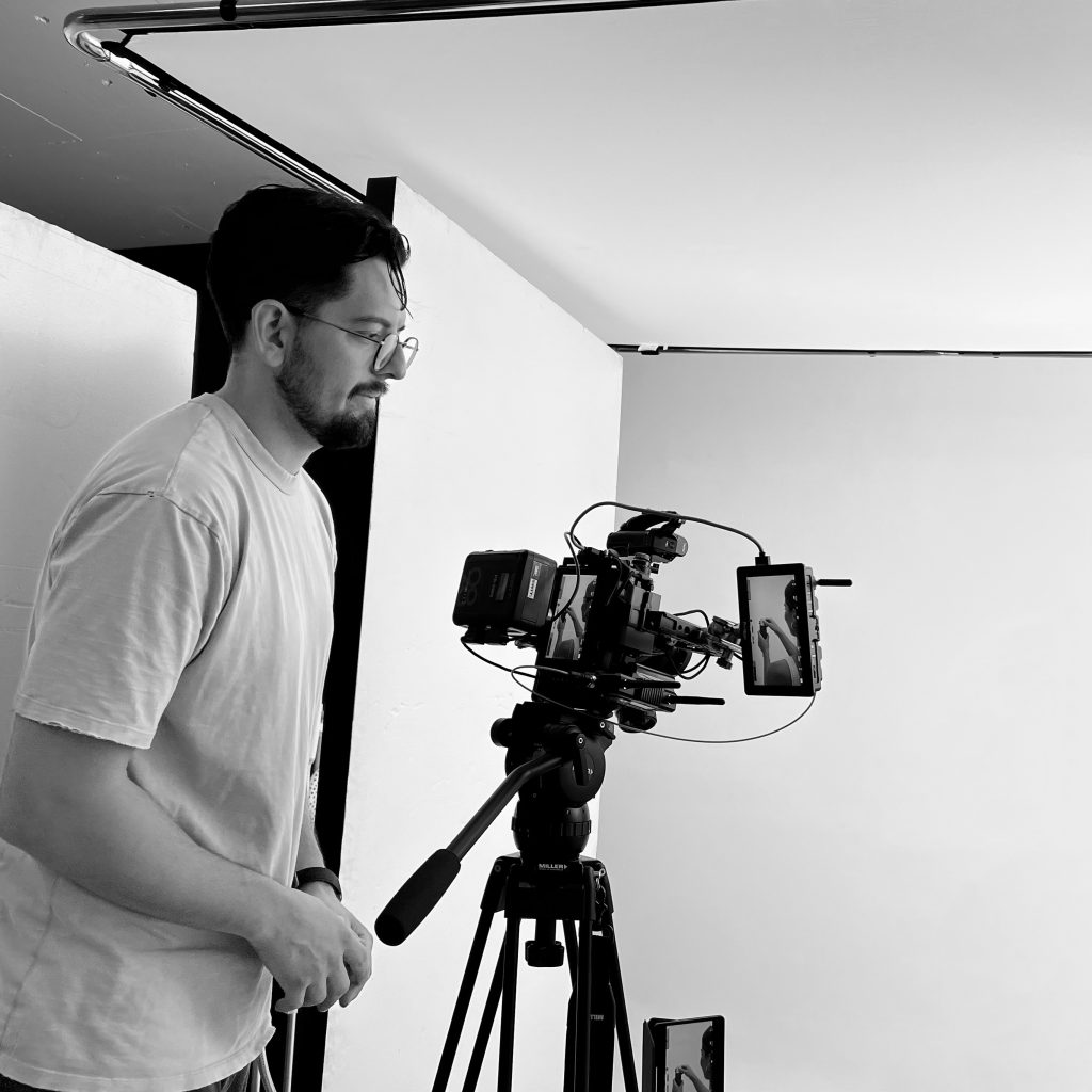 black and white image of videographer ready to start shooting