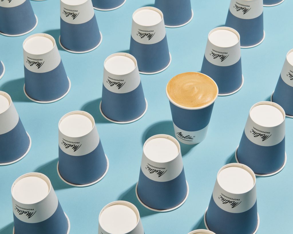 Style product photography image of Melitta Coffee in rows on blue background