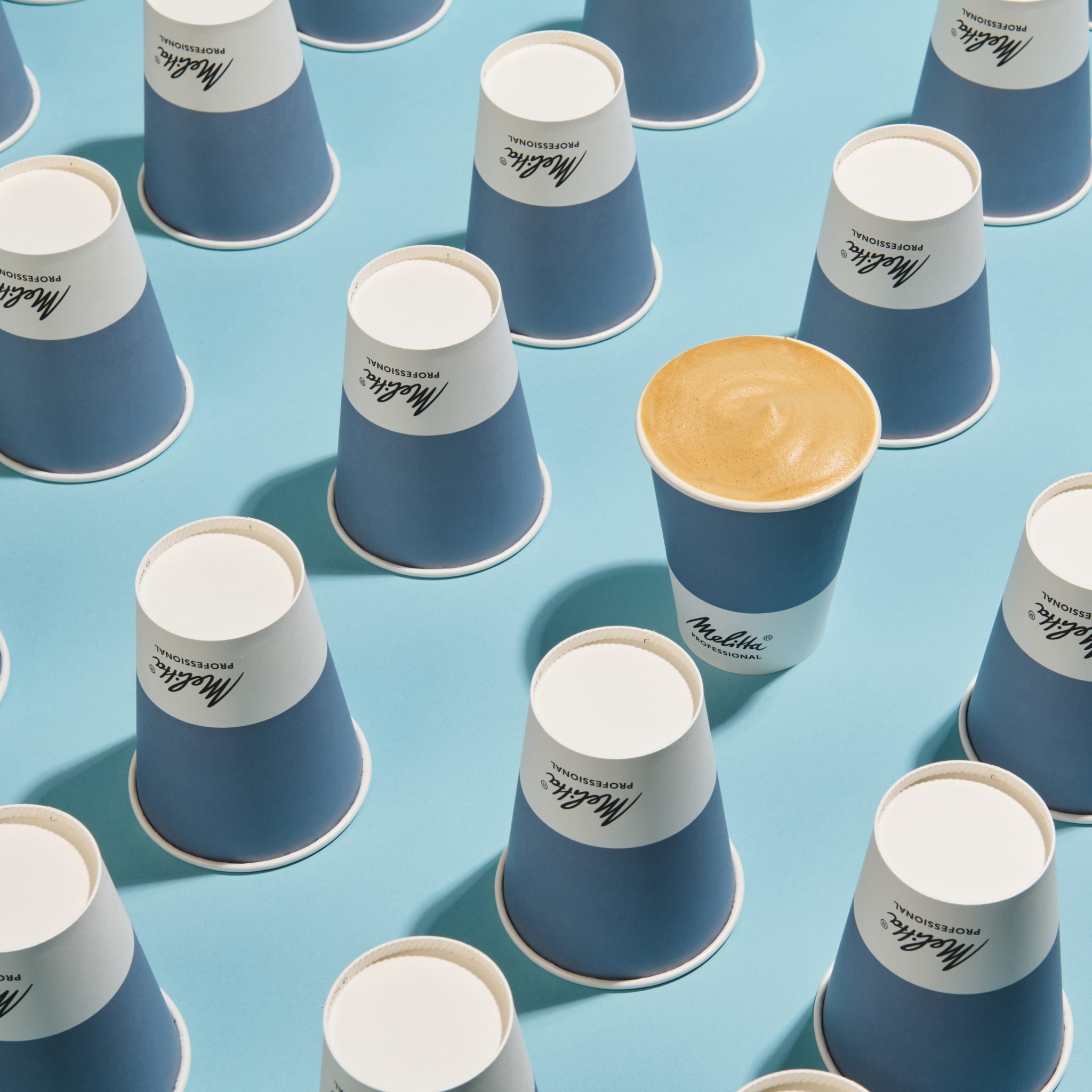Style product photography image of Melitta Coffee in rows on blue background